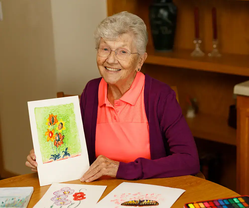 Resident showing off her artwork