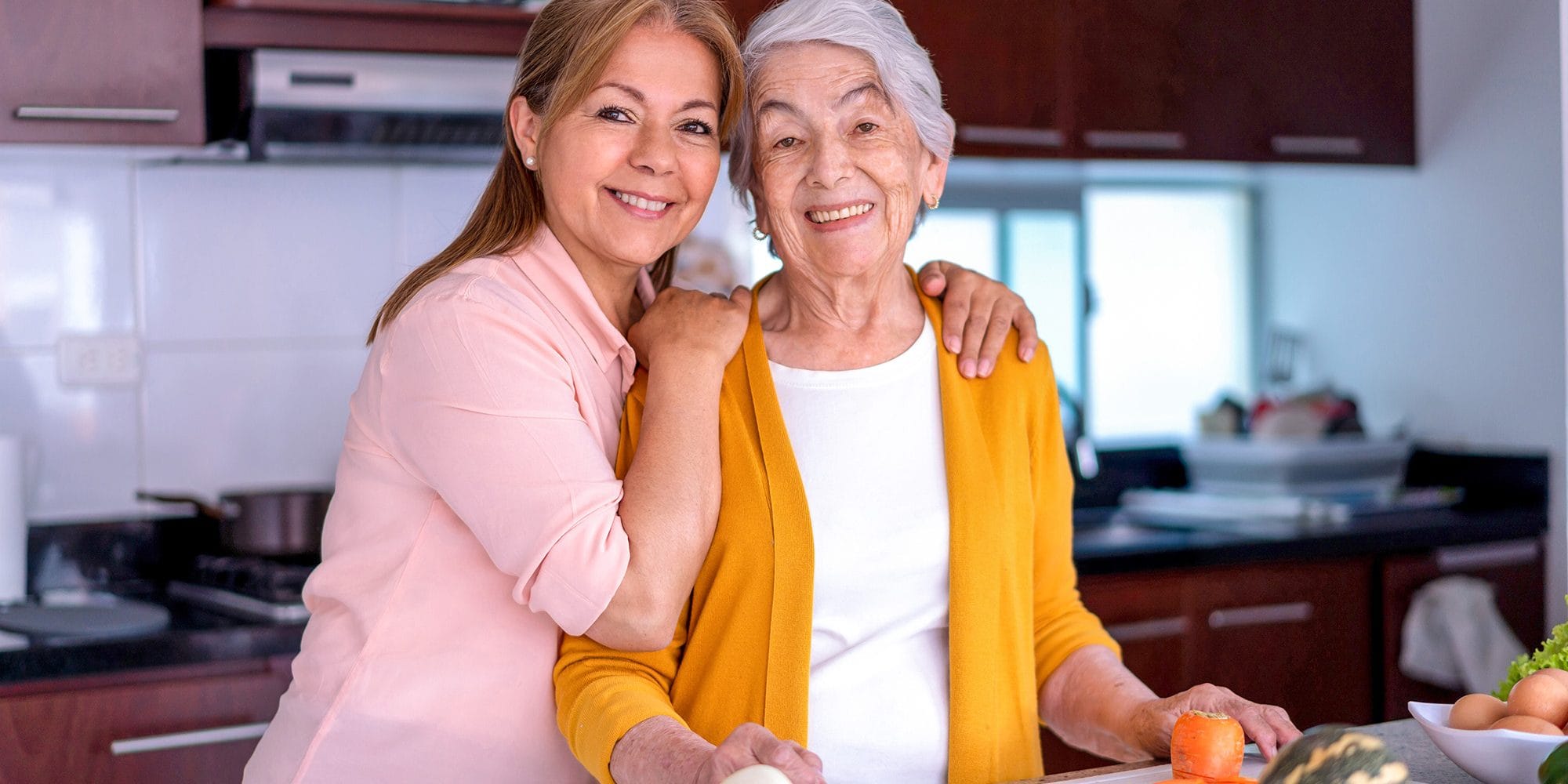 Woman with her senior mother in the kitchen Family Guide for Those Considering Senior Living